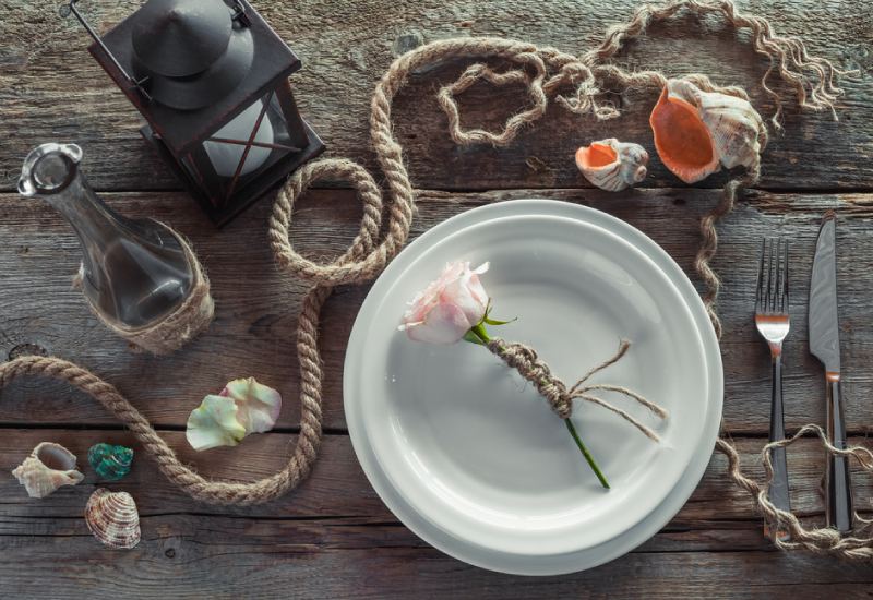 a wooden table topped with plates of food on a plate